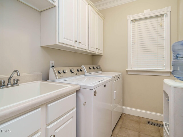8504 Carlton Oaks Dr, Wake Forest, NC 27587 - laundry room with cabinet space, washer and clothes dryer, and light tile patterned floors