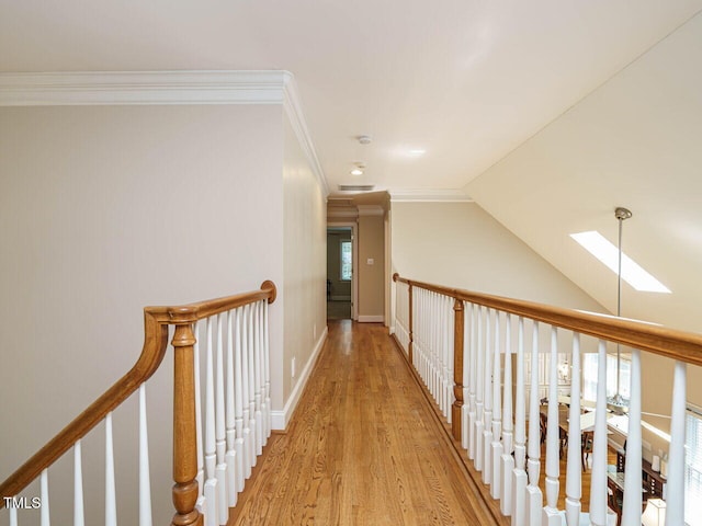 8504 Carlton Oaks Dr, Wake Forest, NC 27587 - corridor featuring a skylight, light wood finished floors, crown molding, lofted ceiling, and an upstairs landing