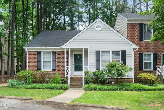 213 Bracken Ct, Raleigh, NC 27615 - view of front of property featuring a front yard, brick siding, and roof with shingles
