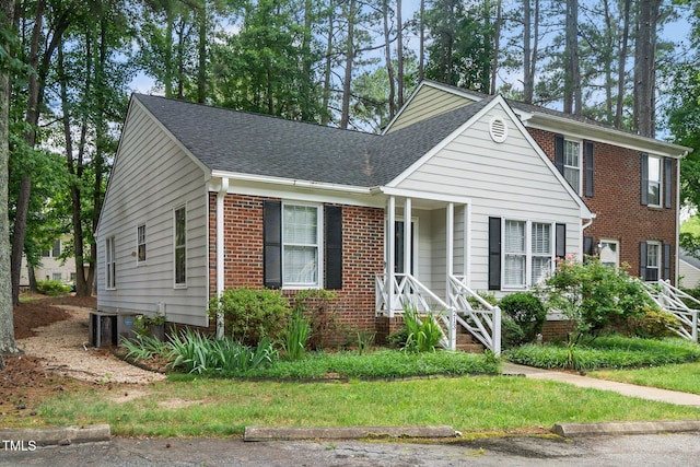 213 Bracken Ct, Raleigh, NC 27615 - view of front of home with a shingled roof and brick siding