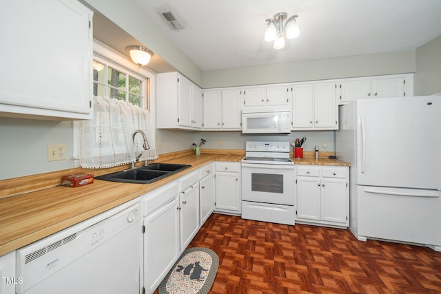 213 Bracken Ct, Raleigh, NC 27615 - kitchen featuring white appliances, white cabinetry, and light countertops