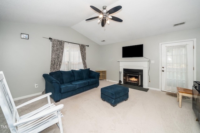 213 Bracken Ct, Raleigh, NC 27615 - carpeted living area featuring a ceiling fan, a warm lit fireplace, and lofted ceiling