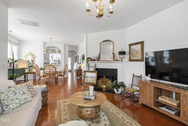 818 Bryant St, Raleigh, NC 27603 - living room featuring a chandelier, wood finished floors, and a fireplace with flush hearth