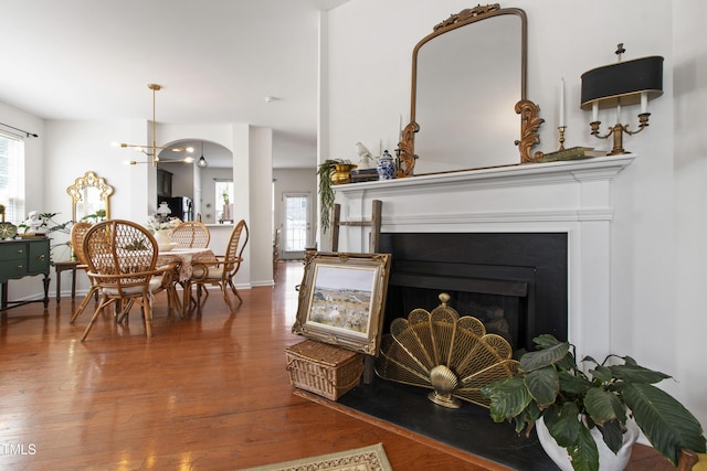 818 Bryant St, Raleigh, NC 27603 - living area featuring wood finished floors, arched walkways, and a fireplace with flush hearth