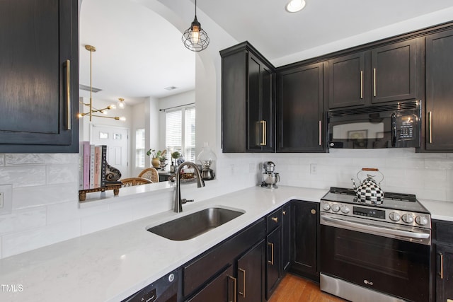818 Bryant St, Raleigh, NC 27603 - kitchen with stainless steel range, black microwave, arched walkways, and tasteful backsplash