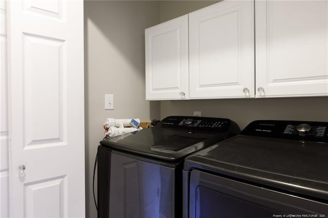 6529 Jacobs Creek Cir, Fayetteville, NC 28306 - laundry room with washer and clothes dryer and cabinet space