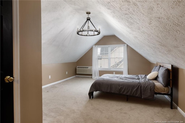 6529 Jacobs Creek Cir, Fayetteville, NC 28306 - carpeted bedroom featuring baseboards, a textured ceiling, lofted ceiling, and a wall mounted air conditioner