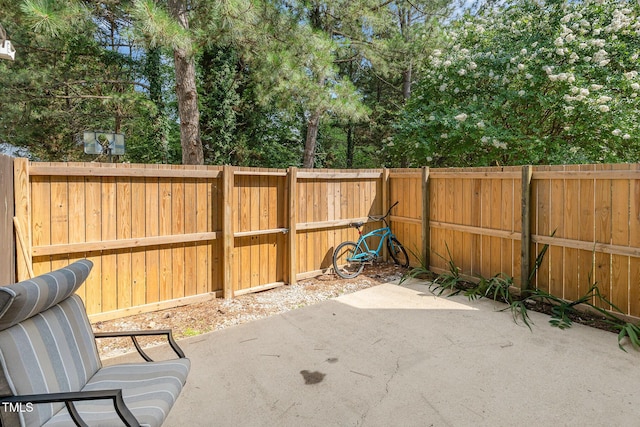 2600 Dwight Pl, Raleigh, NC 27610 - fenced backyard featuring a patio area and view of wooded area