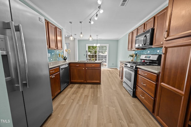 5561 Roan Mountain Pl, Raleigh, NC 27613 - kitchen featuring appliances with stainless steel finishes, a peninsula, light wood-style floors, tasteful backsplash, and brown cabinetry