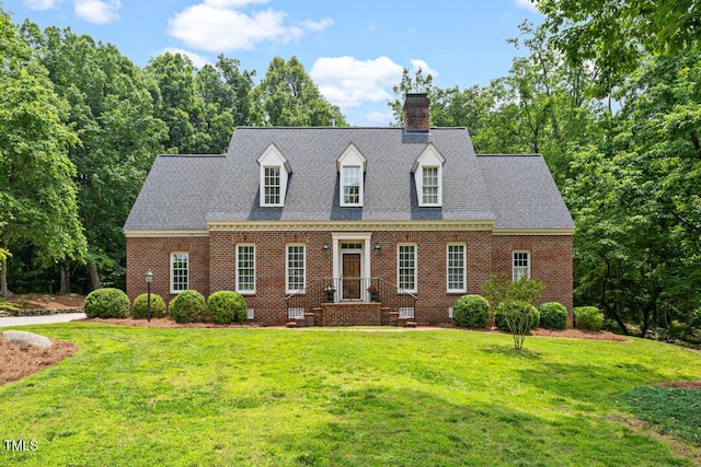 305 Lochridge Dr, Roxboro, NC 27573 - view of front facade featuring a chimney, a front lawn, and brick siding
