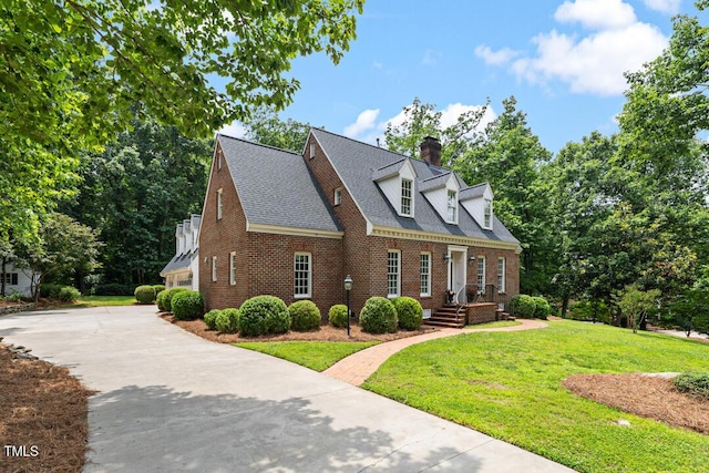 305 Lochridge Dr, Roxboro, NC 27573 - view of front of home featuring brick siding, a chimney, a front lawn, concrete driveway, and a shingled roof