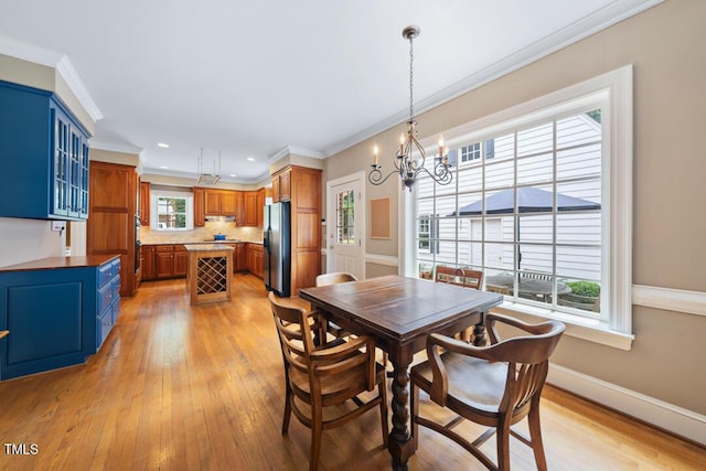305 Lochridge Dr, Roxboro, NC 27573 - dining room with a chandelier, light wood-type flooring, crown molding, and recessed lighting