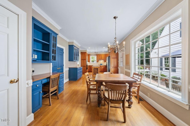 305 Lochridge Dr, Roxboro, NC 27573 - dining room featuring crown molding, light wood-style flooring, built in study area, a chandelier, and recessed lighting