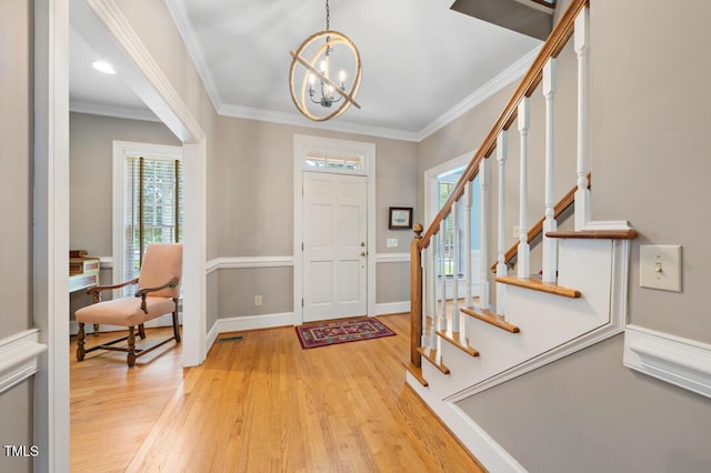 305 Lochridge Dr, Roxboro, NC 27573 - entrance foyer featuring a chandelier, stairs, light wood-style floors, and crown molding
