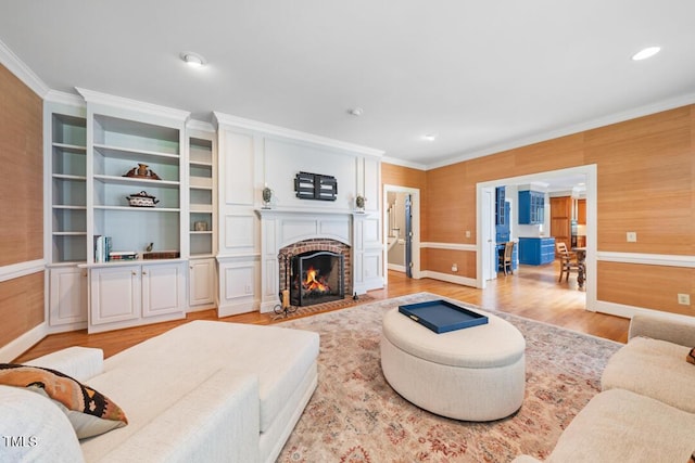 305 Lochridge Dr, Roxboro, NC 27573 - living room with crown molding, light wood finished floors, a brick fireplace, and recessed lighting