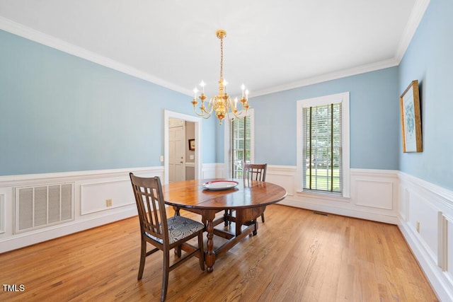 305 Lochridge Dr, Roxboro, NC 27573 - dining room with a chandelier, a wainscoted wall, light wood finished floors, and ornamental molding