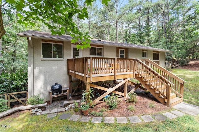 6609 Hunters Ln, Durham, NC 27713 - back of property with brick siding, a wooden deck, and stairs