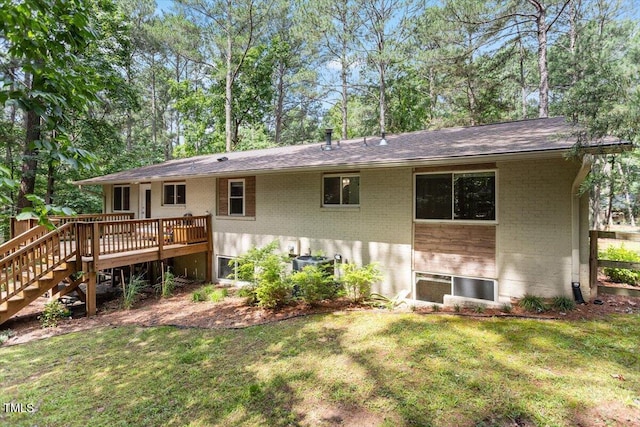 6609 Hunters Ln, Durham, NC 27713 - rear view of property with brick siding, a deck, a yard, and stairs