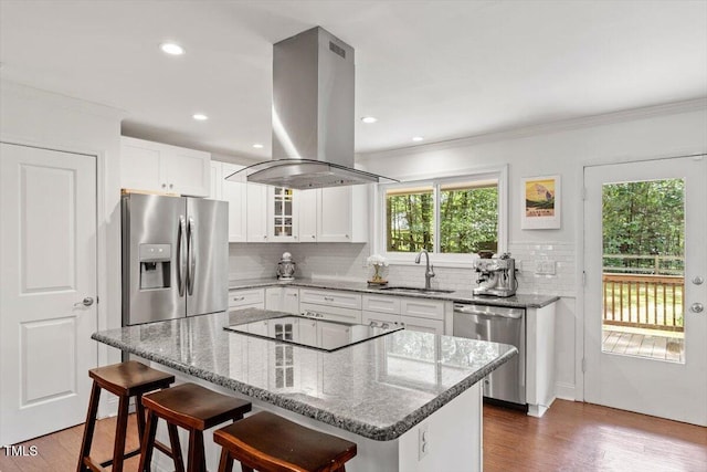 6609 Hunters Ln, Durham, NC 27713 - kitchen featuring stainless steel appliances, island range hood, decorative backsplash, ornamental molding, and light stone counters