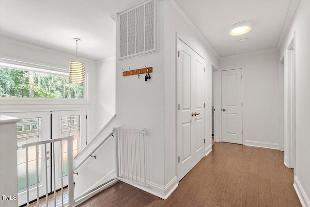6609 Hunters Ln, Durham, NC 27713 - hallway featuring dark wood-type flooring, ornamental molding, and an upstairs landing