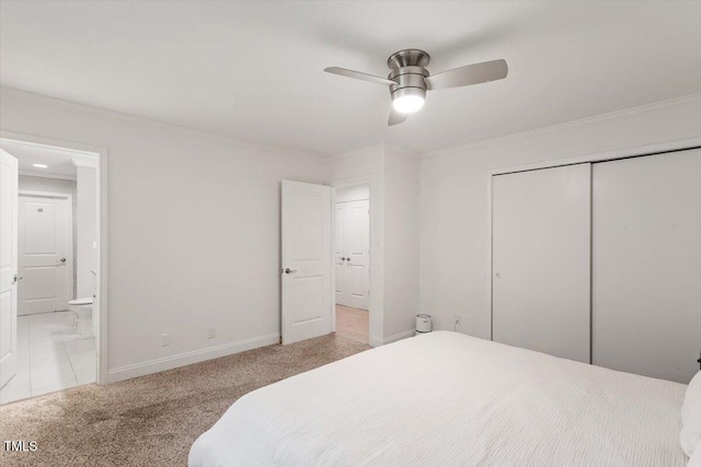 6609 Hunters Ln, Durham, NC 27713 - bedroom with ornamental molding, light colored carpet, a closet, connected bathroom, and a ceiling fan