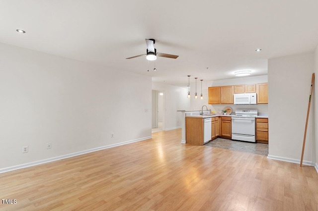 1851 Trailwood Heights Ln, Raleigh, NC 27603 - kitchen with white appliances, open floor plan, a peninsula, light countertops, and a ceiling fan