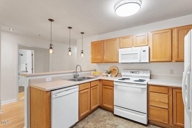 1851 Trailwood Heights Ln, Raleigh, NC 27603 - kitchen with white appliances, a peninsula, light countertops, and hanging light fixtures