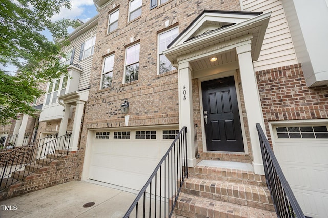 404 Panorama Park Pl, Cary, NC 27519 - doorway to property featuring a garage, brick siding, and driveway