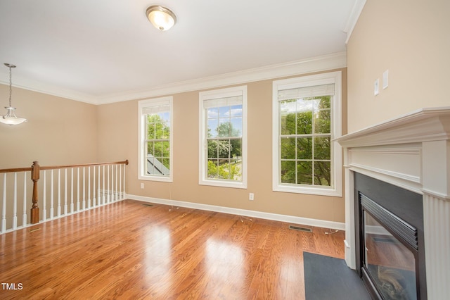 404 Panorama Park Pl, Cary, NC 27519 - unfurnished living room featuring plenty of natural light, crown molding, a fireplace with flush hearth, and wood finished floors