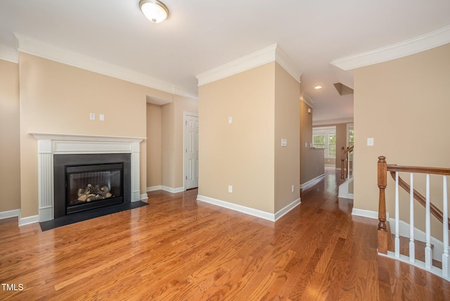 404 Panorama Park Pl, Cary, NC 27519 - unfurnished living room featuring ornamental molding, light wood-style flooring, and a fireplace with flush hearth