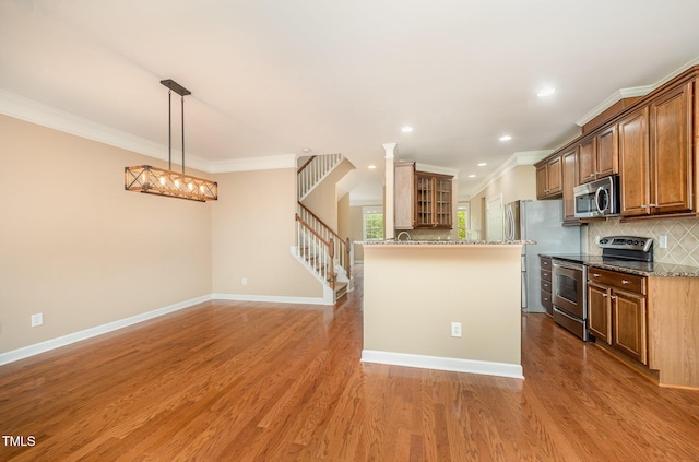 404 Panorama Park Pl, Cary, NC 27519 - kitchen featuring stainless steel appliances, ornamental molding, tasteful backsplash, stone counters, and light wood-style flooring