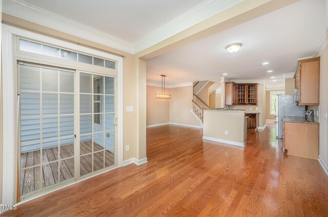 404 Panorama Park Pl, Cary, NC 27519 - kitchen featuring ornamental molding, brown cabinets, stainless steel appliances, wood finished floors, and glass insert cabinets