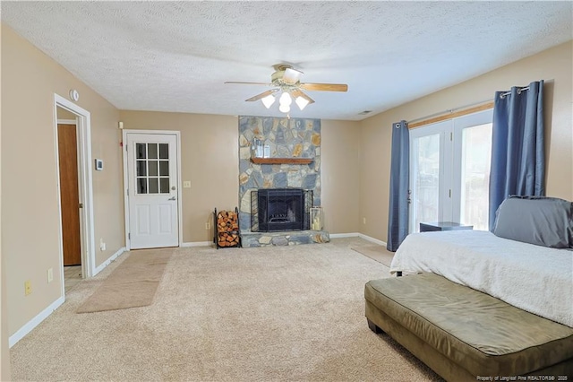 874 Santiato Dr, Fayetteville, NC 28314 - bedroom featuring access to outside, light colored carpet, baseboards, a textured ceiling, and a fireplace
