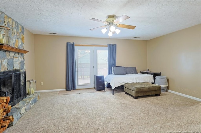 874 Santiato Dr, Fayetteville, NC 28314 - bedroom featuring a textured ceiling, carpet, access to exterior, a fireplace, and a ceiling fan