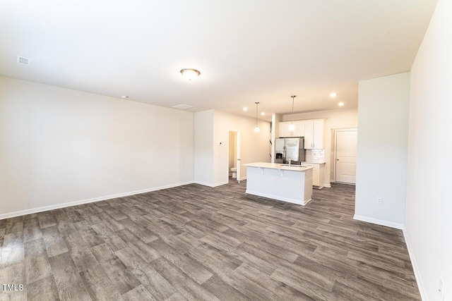 227 Liam St, Clayton, NC 27520 - unfurnished living room featuring dark wood-style flooring, baseboards, and recessed lighting