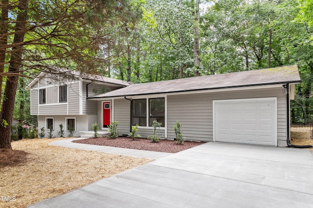 2905 Scuppernong Ln, Durham, NC 27703 - split level home with a garage, driveway, and roof with shingles