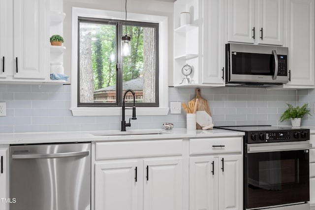 2905 Scuppernong Ln, Durham, NC 27703 - kitchen with open shelves, stainless steel appliances, white cabinetry, and light countertops