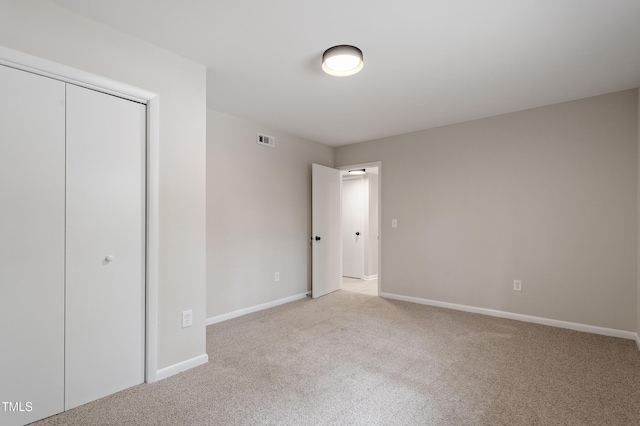 2905 Scuppernong Ln, Durham, NC 27703 - unfurnished bedroom with light colored carpet and a closet