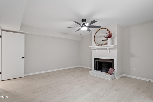 2905 Scuppernong Ln, Durham, NC 27703 - unfurnished living room featuring a ceiling fan, light wood finished floors, and a fireplace with raised hearth