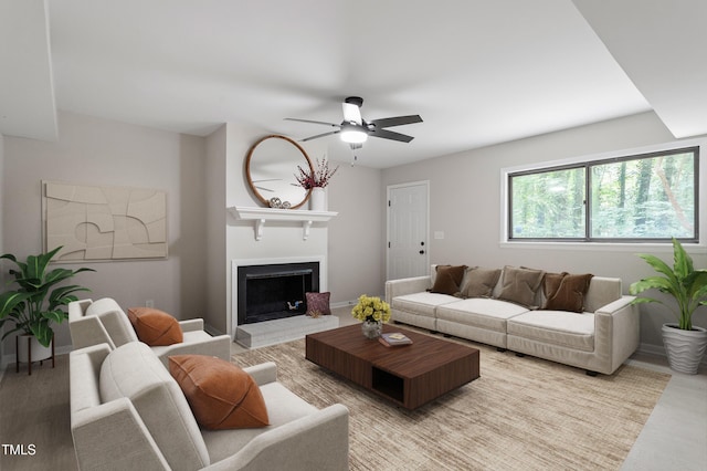 2905 Scuppernong Ln, Durham, NC 27703 - living area featuring ceiling fan, a fireplace with raised hearth, and light wood finished floors