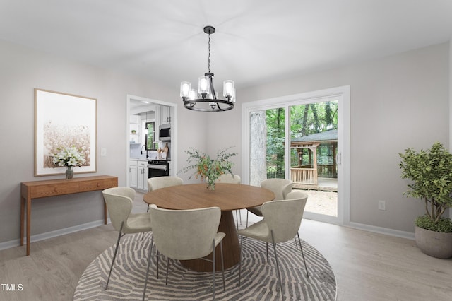 2905 Scuppernong Ln, Durham, NC 27703 - dining room with a chandelier and light wood-type flooring