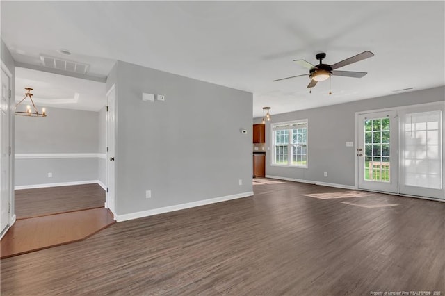 9031 Grouse Run Ln, Fayetteville, NC 28314 - unfurnished living room with dark wood-style floors, ceiling fan, baseboards, and a chandelier