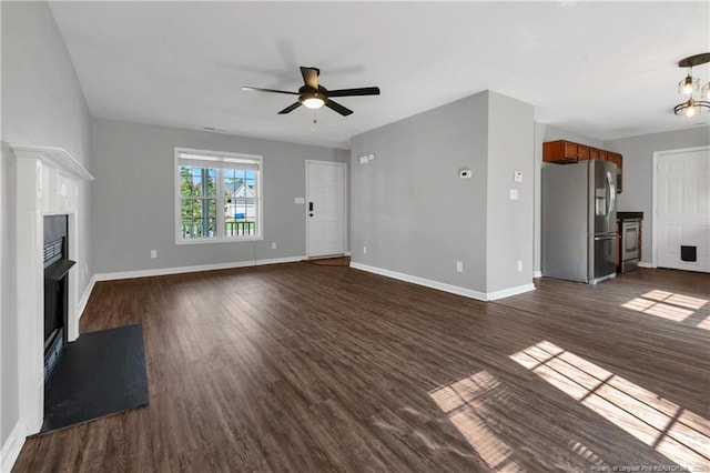 9031 Grouse Run Ln, Fayetteville, NC 28314 - unfurnished living room featuring a fireplace with flush hearth, a ceiling fan, dark wood-type flooring, and baseboards