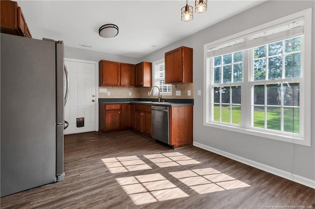 9031 Grouse Run Ln, Fayetteville, NC 28314 - kitchen featuring stainless steel appliances, dark wood finished floors, baseboards, and decorative backsplash