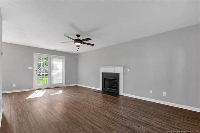 9031 Grouse Run Ln, Fayetteville, NC 28314 - unfurnished living room with a ceiling fan, dark wood-style flooring, a fireplace with flush hearth, and baseboards