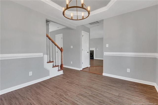 9031 Grouse Run Ln, Fayetteville, NC 28314 - spare room featuring a chandelier, wood finished floors, baseboards, stairway, and a raised ceiling