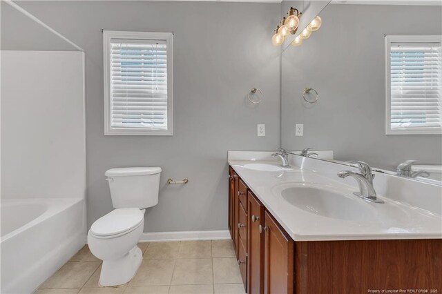 9031 Grouse Run Ln, Fayetteville, NC 28314 - bathroom featuring tile patterned floors, double vanity, plenty of natural light, and toilet