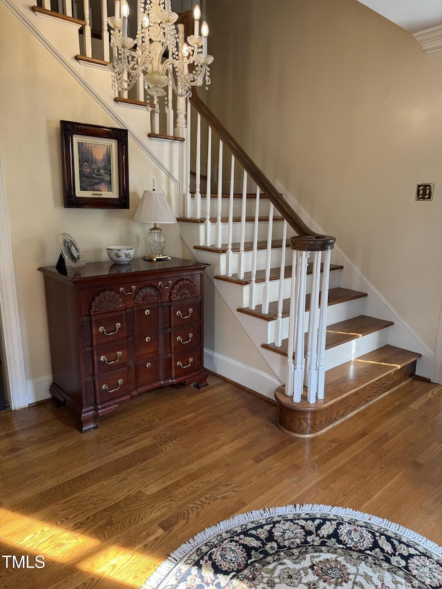 7140 N Ridge Dr, Raleigh, NC 27615 - stairway with wood finished floors and a chandelier