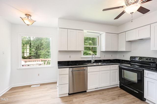 3605 Iron Sight Ct, Raleigh, NC 27616 - kitchen featuring electric range, dishwasher, healthy amount of natural light, and white cabinetry