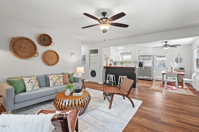 2322 Stroller Ave, Durham, NC 27705 - living area with estacked washer and dryer, a ceiling fan, and wood finished floors